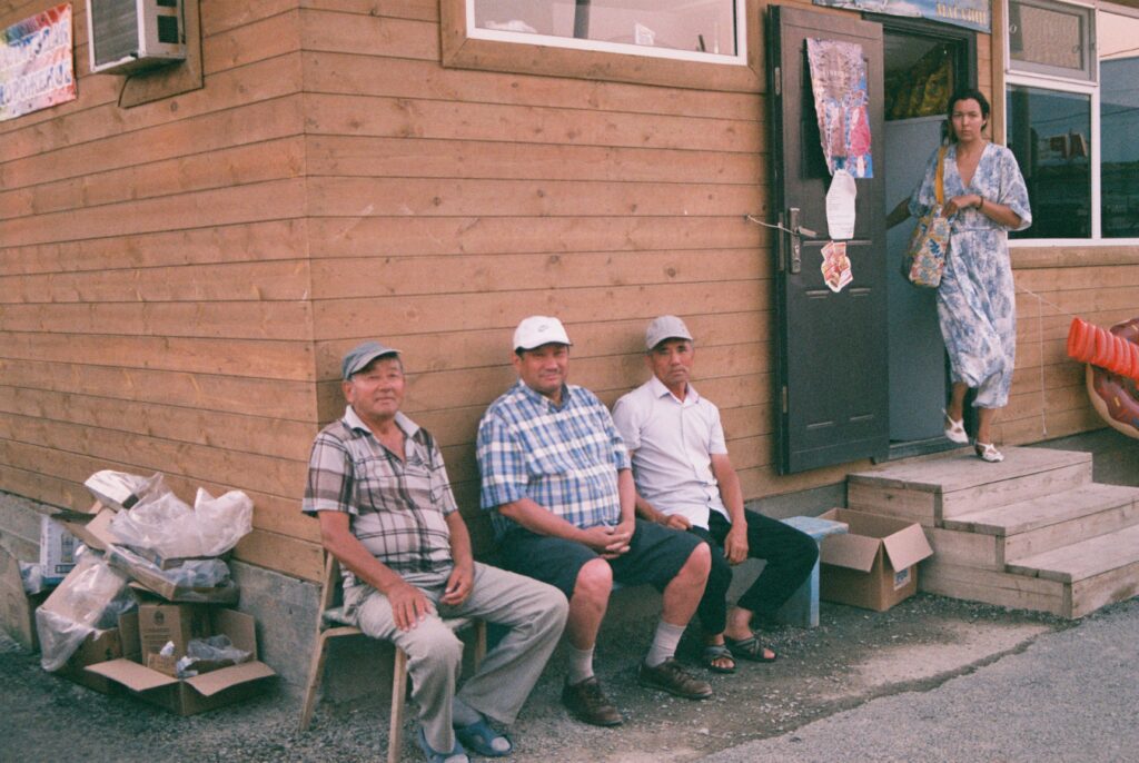 People sat outside a community building.