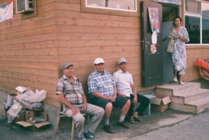 People sat outside a community building.