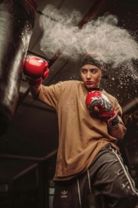 A young woman training with a punchbag.