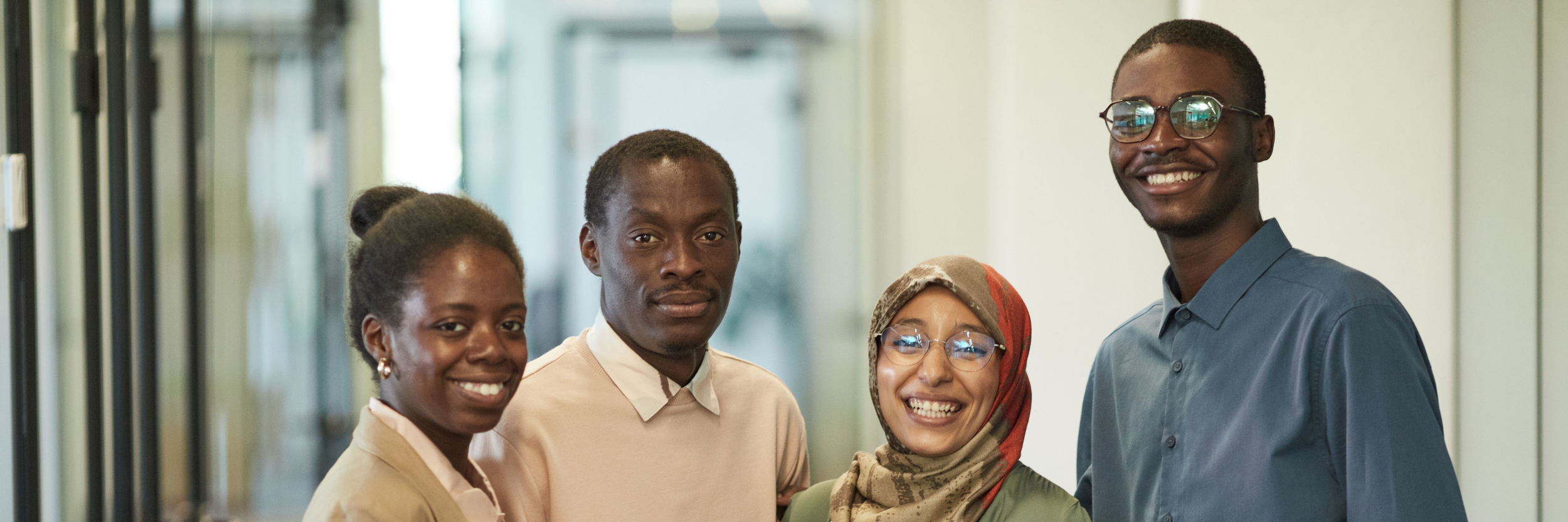 A group of professionals smiling in an office.