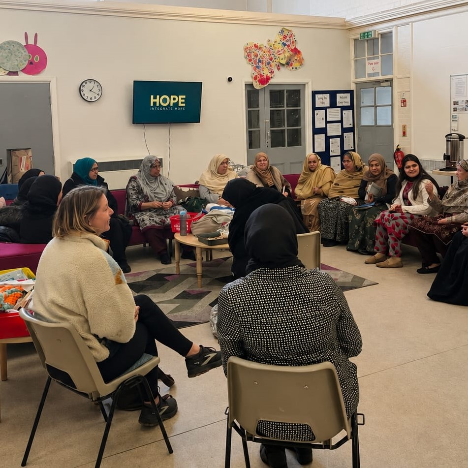 A large group of women gathered in a welcoming community space.