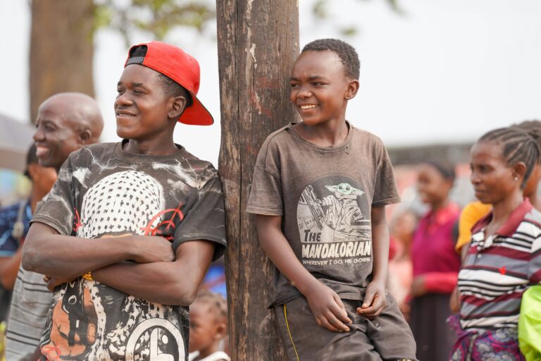 Two young men picked out from a crowd, attending an event.