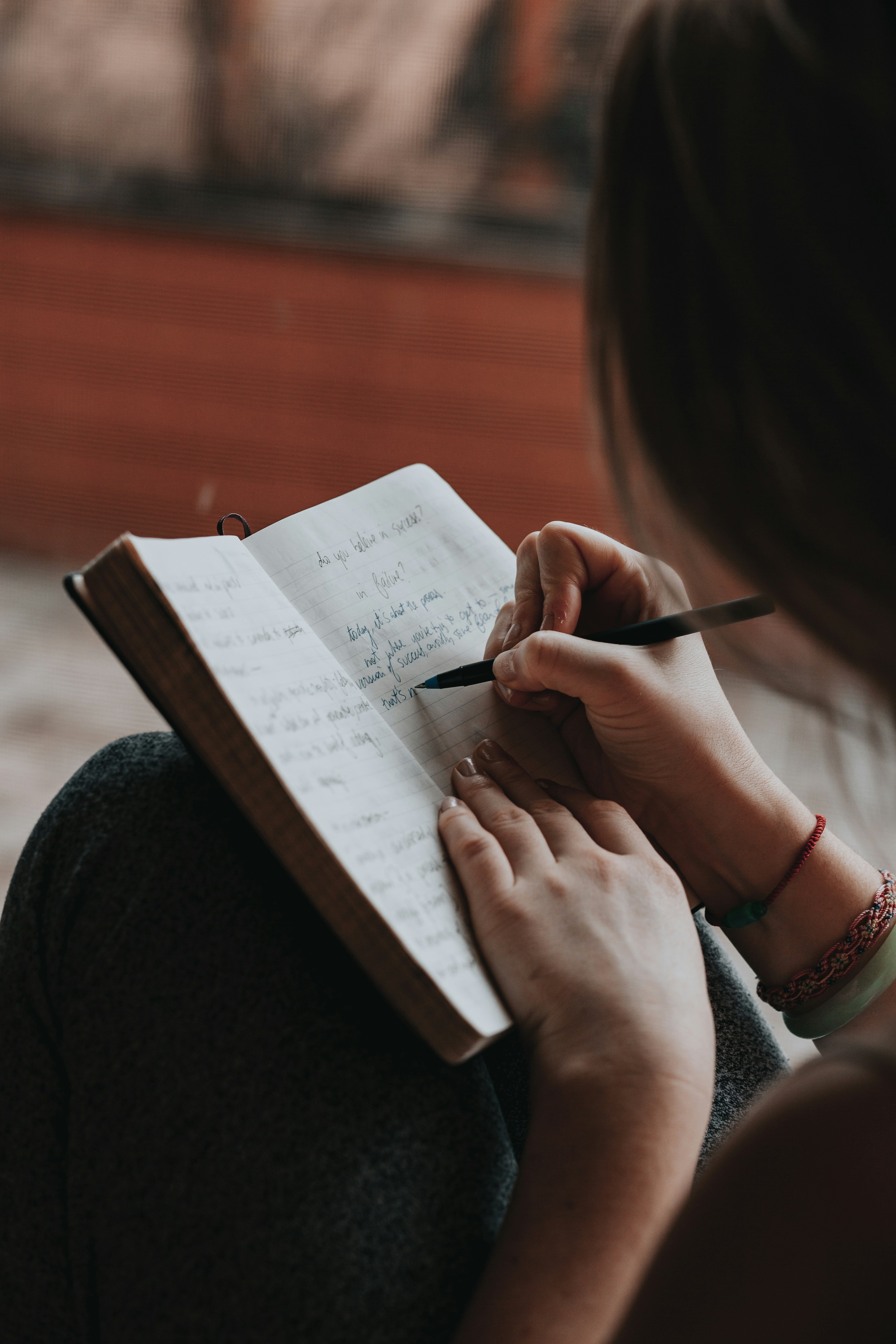 Person writing notes on progress