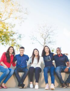 A group of young people smiling and laughing.