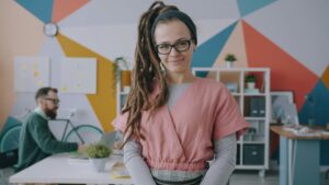A young woman in a colourful modern workspace.